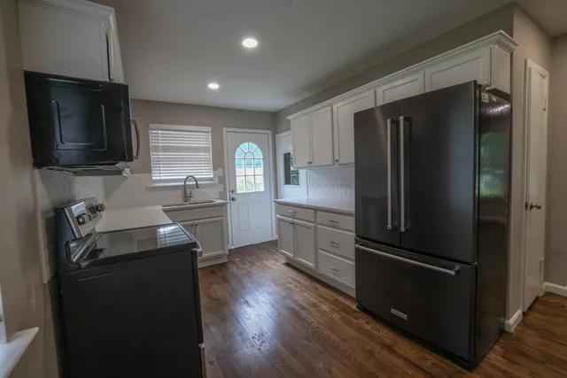 a kitchen with a refrigerator stove and sink