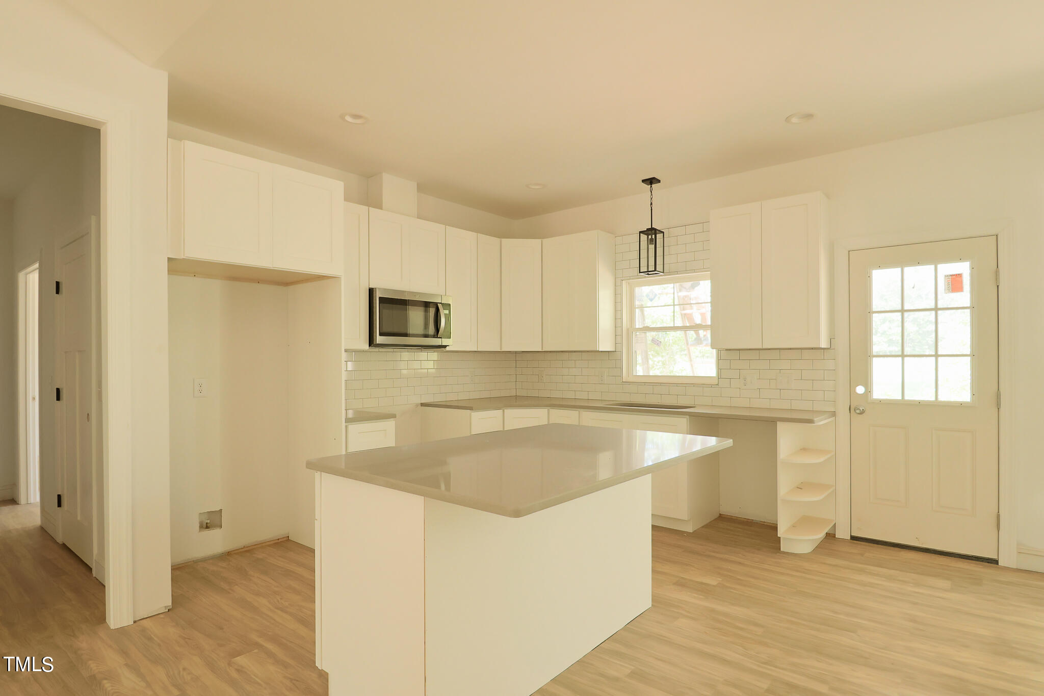 9550 Meredith Drive Rougemont, NC 27572 - Photo 5 of 32 a kitchen with stainless steel appliances granite countertop a sink a stove a refrigerator and white cabinets