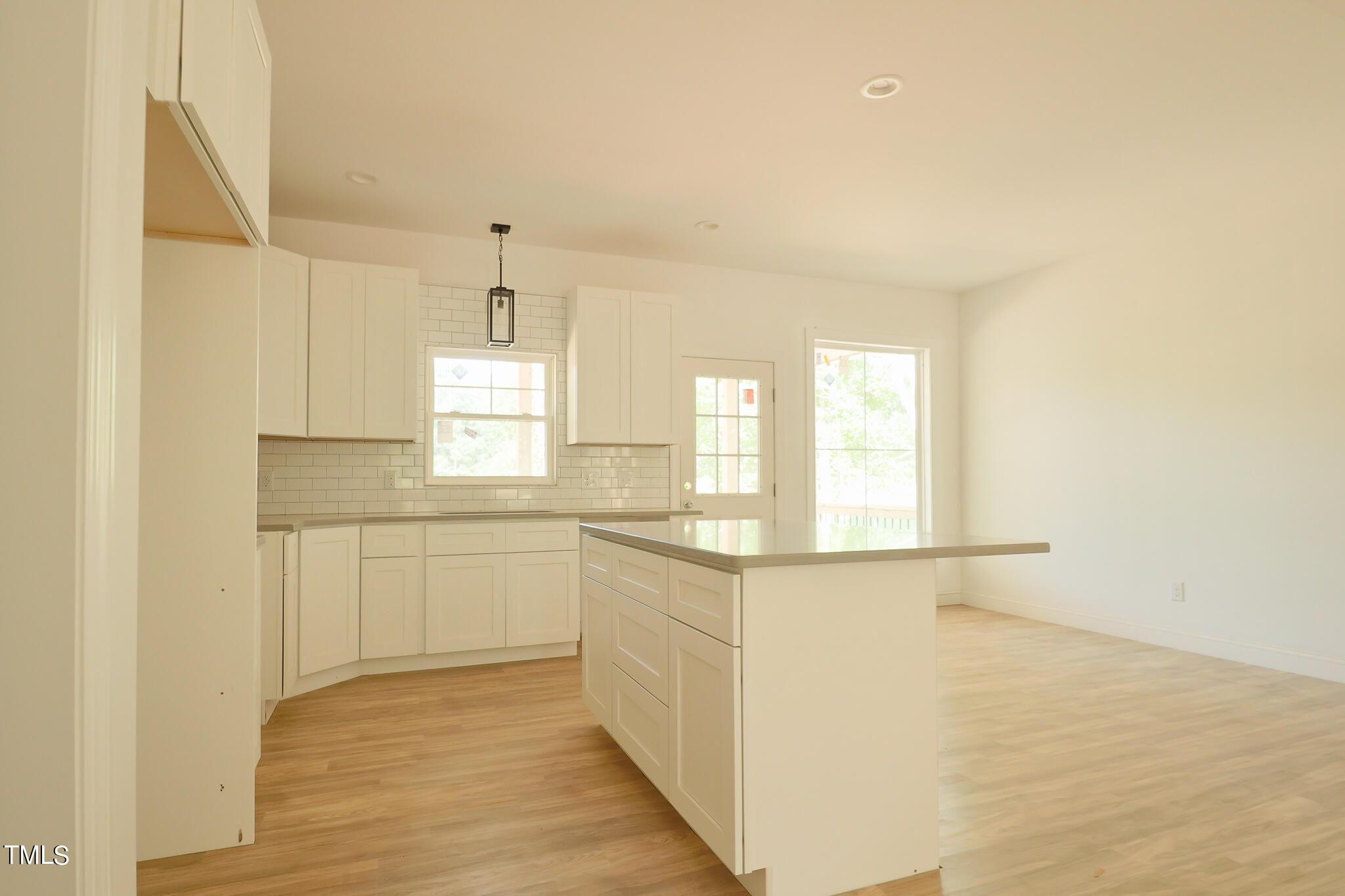 9550 Meredith Drive Rougemont, NC 27572 - Photo 6 of 32 a kitchen with granite countertop white cabinets and white appliances