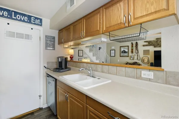 a kitchen with stainless steel appliances a sink a stove and a refrigerator