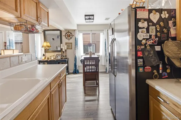 a kitchen with stainless steel appliances granite countertop a refrigerator and a sink
