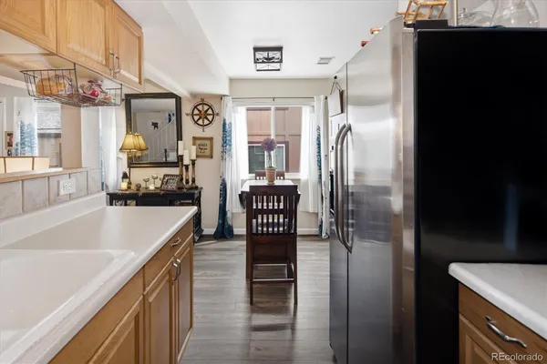 a kitchen with a refrigerator and a sink