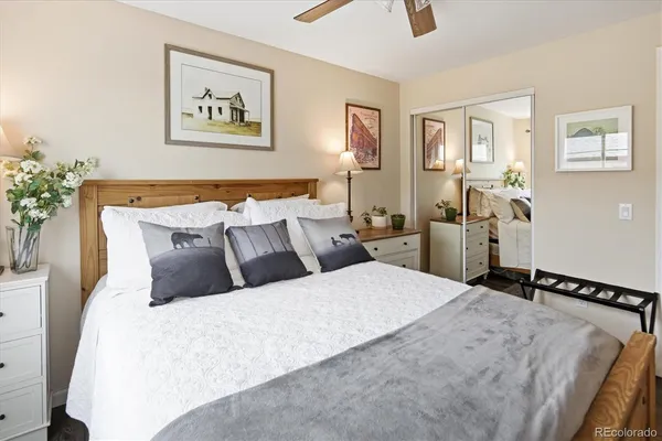 a bedroom with a large bed and a chandelier
