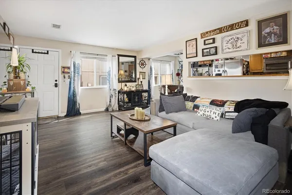 a living room with furniture and wooden floor