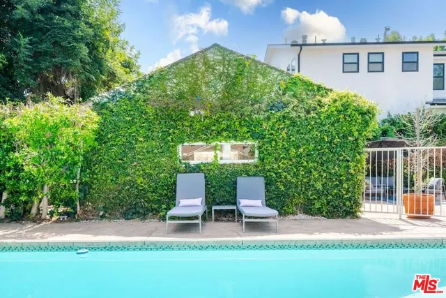 a view of a patio with table and chairs with wooden fence