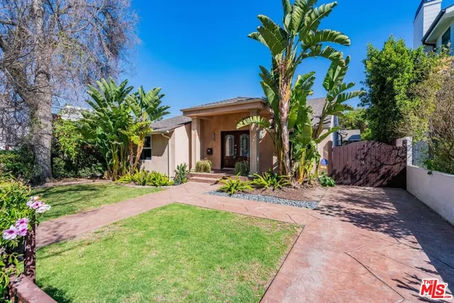 a front view of a house with a yard and porch