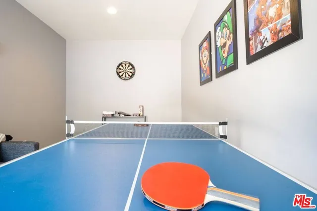 a large kitchen with stainless steel appliances kitchen island granite countertop a large counter top a stove a chimney a sink and a refrigerator