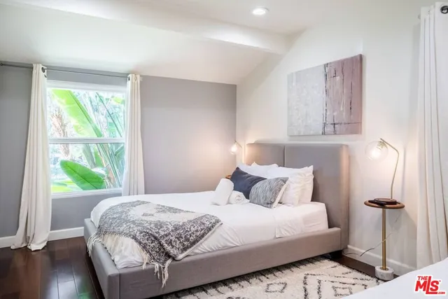 a bedroom with two beds and a flat screen tv