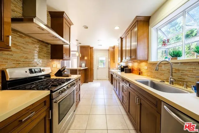 a view of a patio with a table and chairs under an umbrella