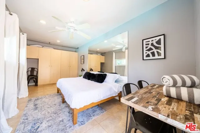 a bedroom with a bed and chandelier