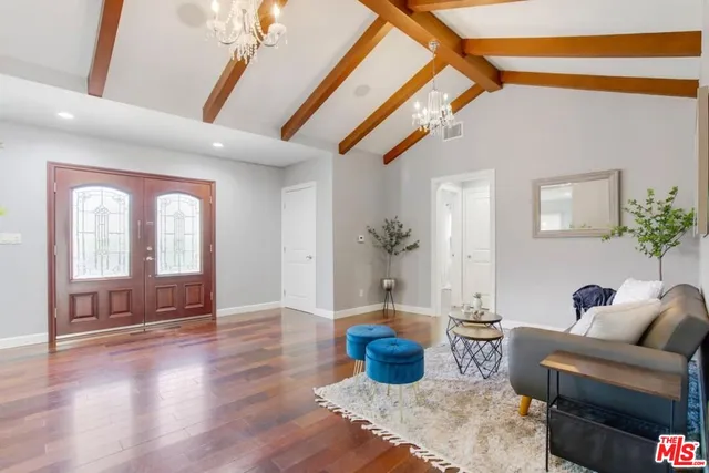 a living room with furniture a couch and a potted plant