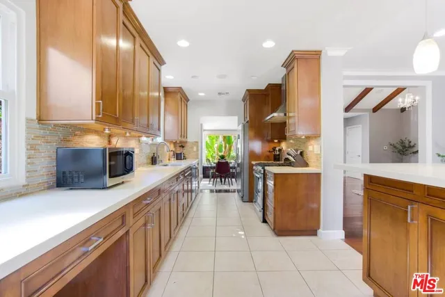 a kitchen with stainless steel appliances granite countertop sink stove and cabinets