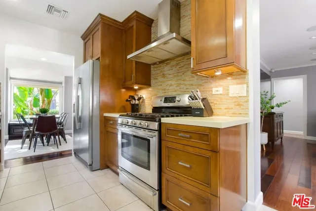 a kitchen with cabinets and chairs