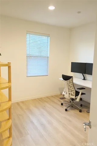 a view of a room with a wooden floor and a window