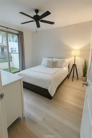 a bedroom with a large bed and a chandelier