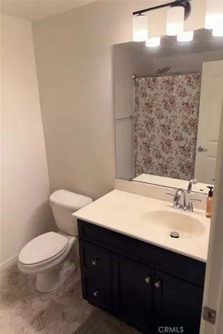 a bathroom with a sink a toilet and mirror