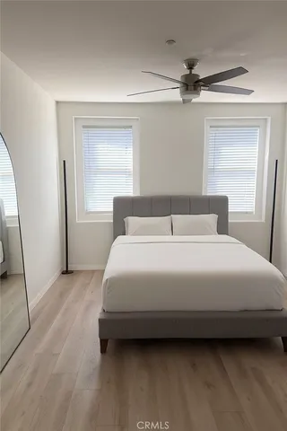 a bedroom with a bed and a large mirror