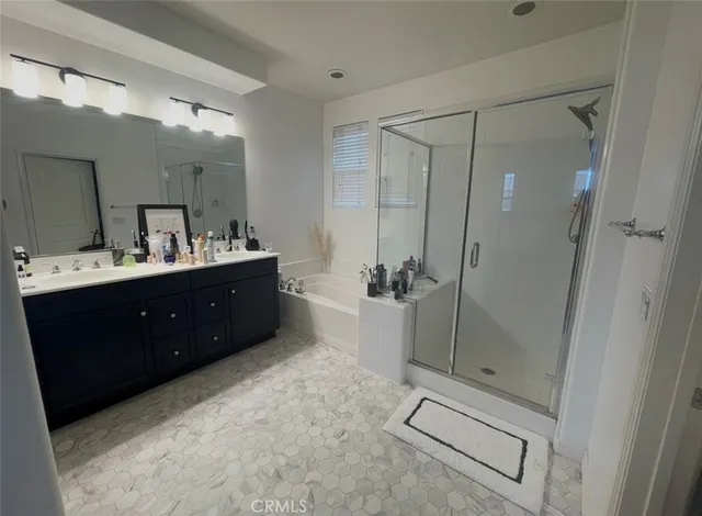 a bathroom with a double vanity sink toilet and shower
