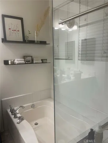a bathroom with a tub and a shower