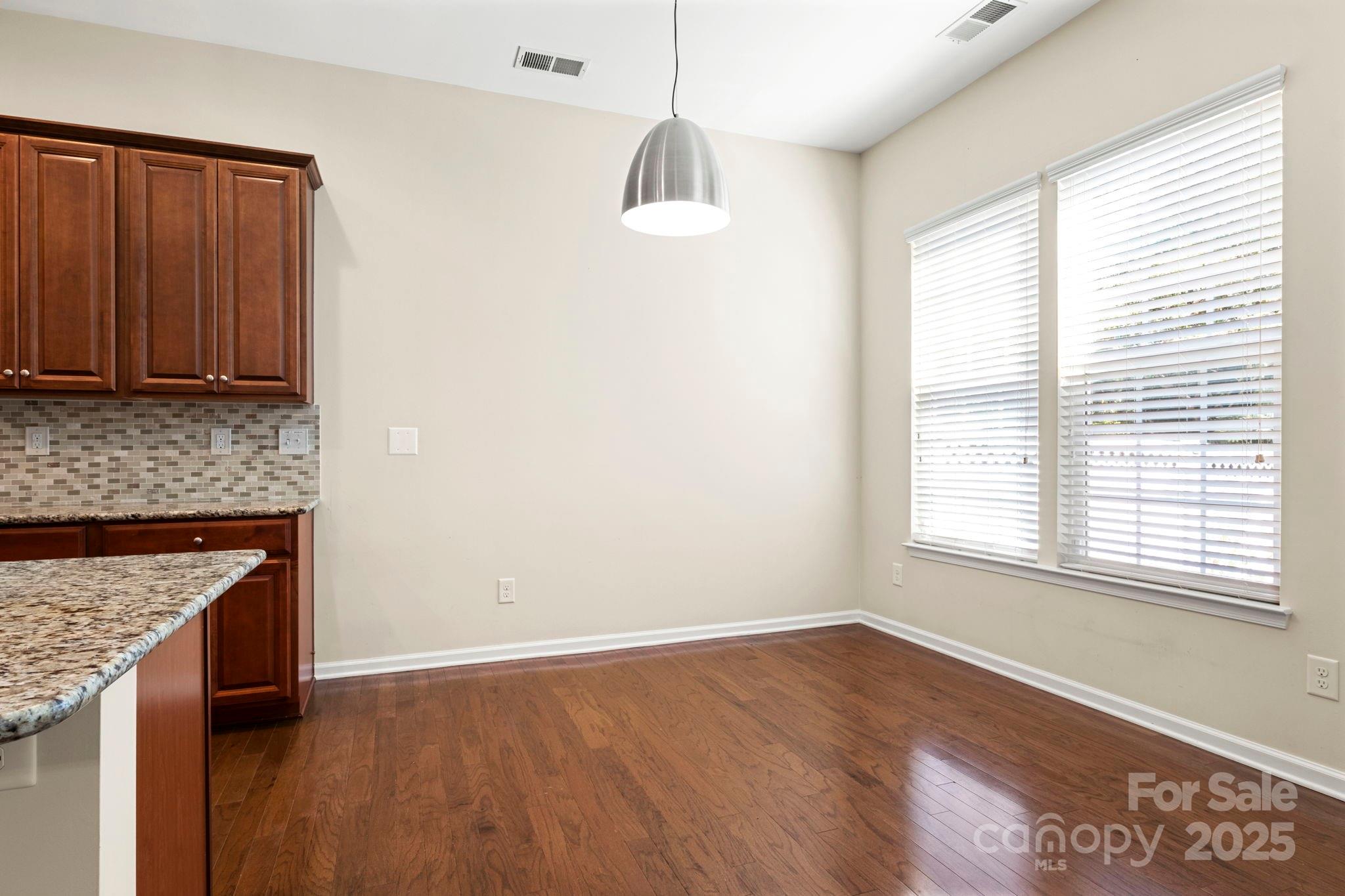 15709 Kiser Corner Lane Davidson, NC 28036 - Photo 11 of 42 an empty room with wooden floor and windows
