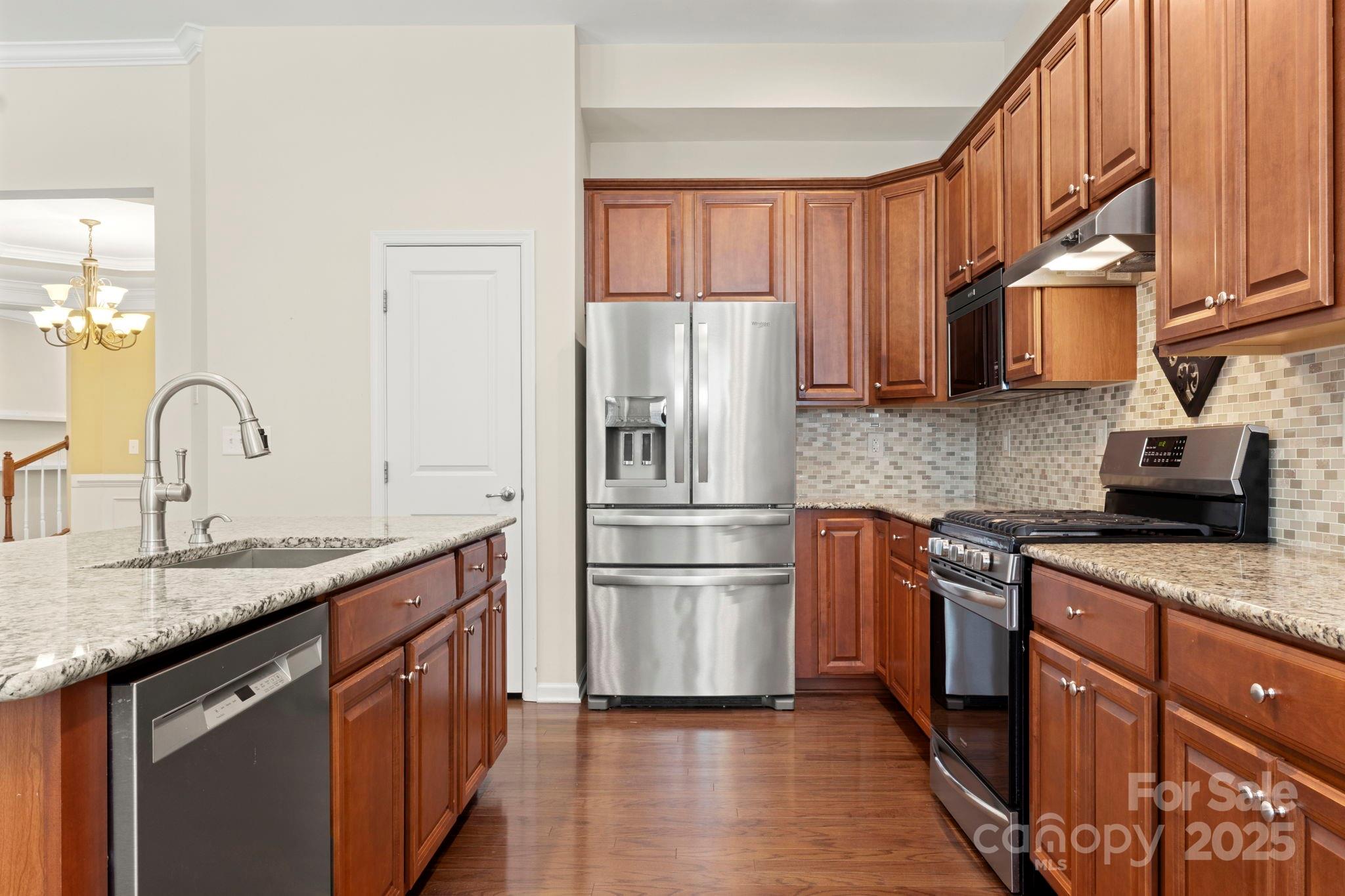 15709 Kiser Corner Lane Davidson, NC 28036 - Photo 13 of 42 a kitchen with granite countertop stainless steel appliances and wooden cabinets