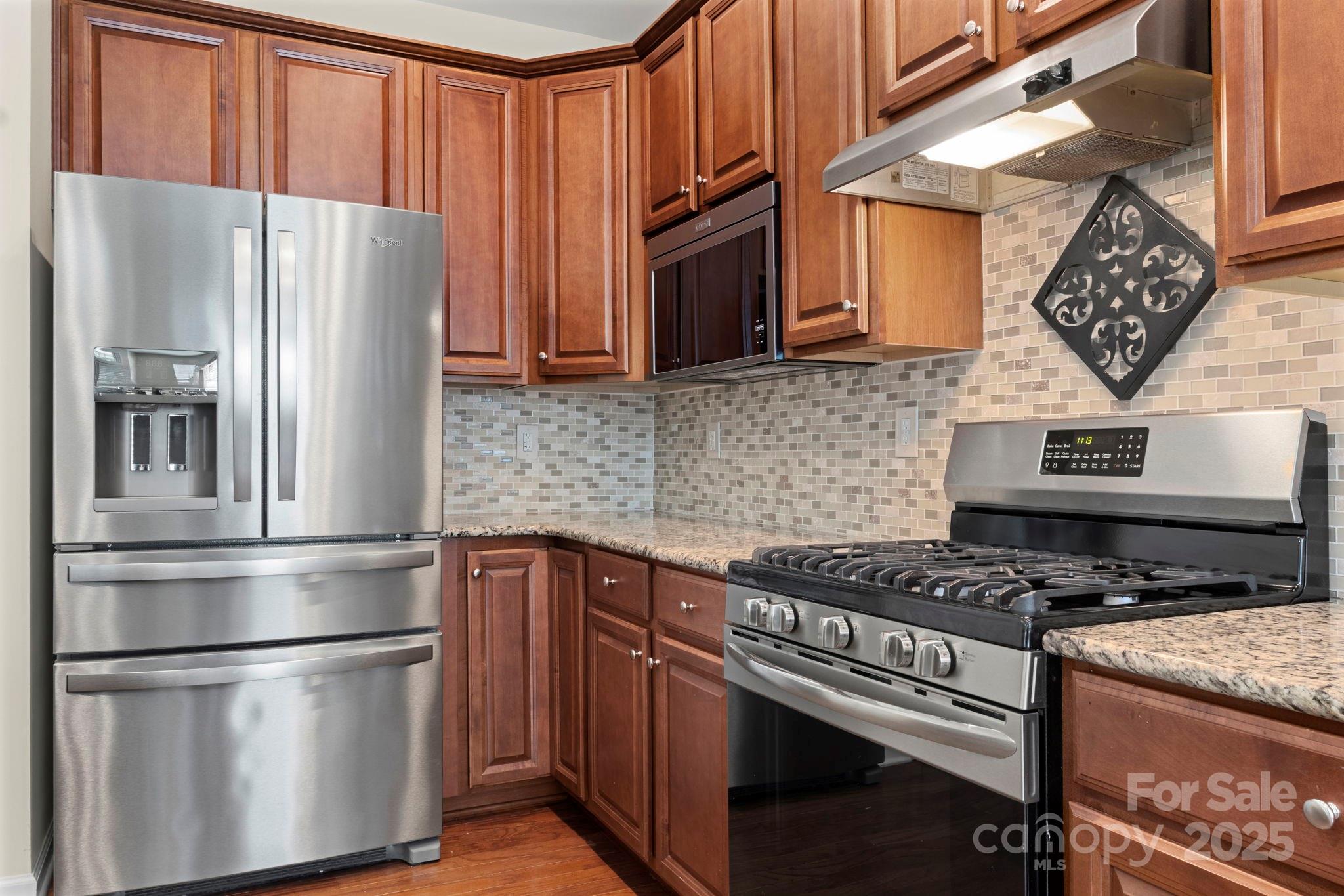 15709 Kiser Corner Lane Davidson, NC 28036 - Photo 14 of 42 a kitchen with stainless steel appliances granite countertop a refrigerator stove and sink