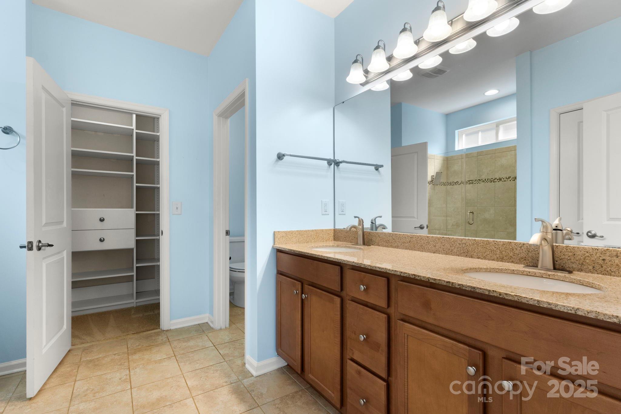 15709 Kiser Corner Lane Davidson, NC 28036 - Photo 18 of 42 a bathroom with a granite countertop double vanity sink a vanity and a mirror