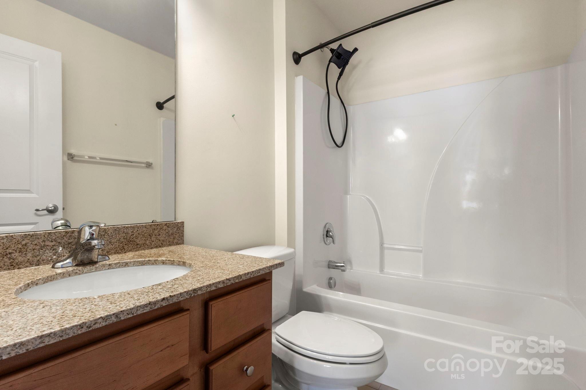 15709 Kiser Corner Lane Davidson, NC 28036 - Photo 32 of 42 a bathroom with a granite countertop sink toilet vanity shower and bathtub