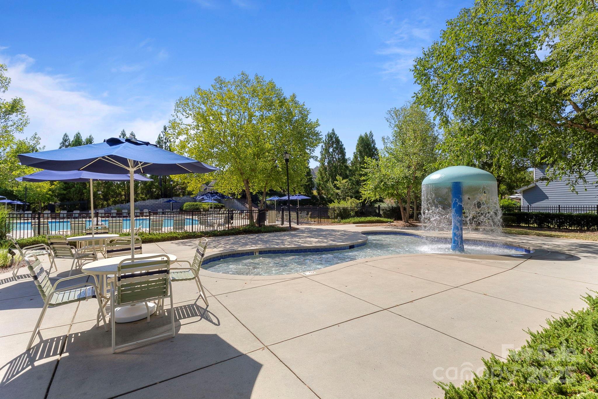 15709 Kiser Corner Lane Davidson, NC 28036 - Photo 39 of 42 a view of a patio with a table and chairs under an umbrella