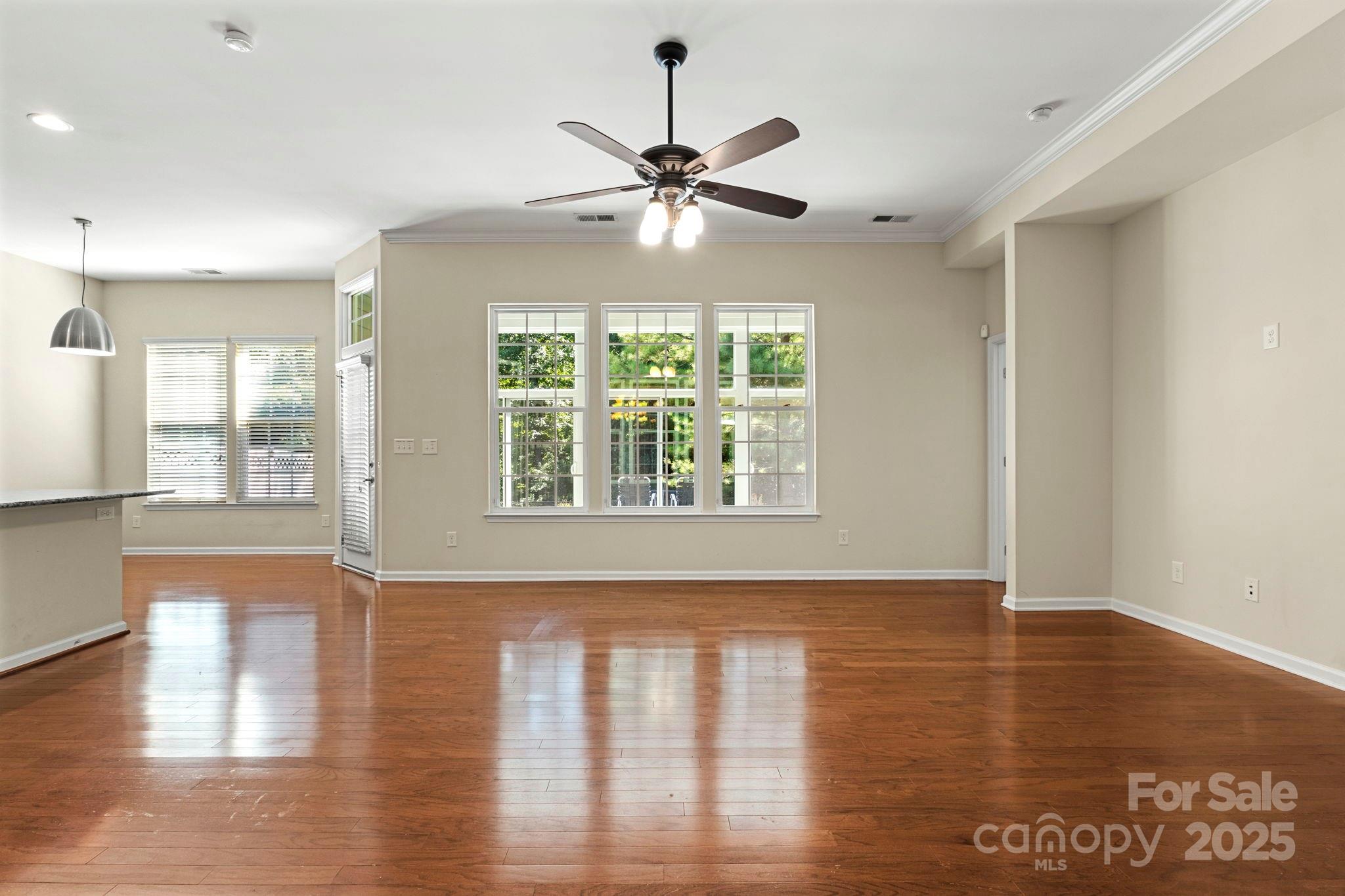 15709 Kiser Corner Lane Davidson, NC 28036 - Photo 8 of 42 a view of an empty room with wooden floor and a window
