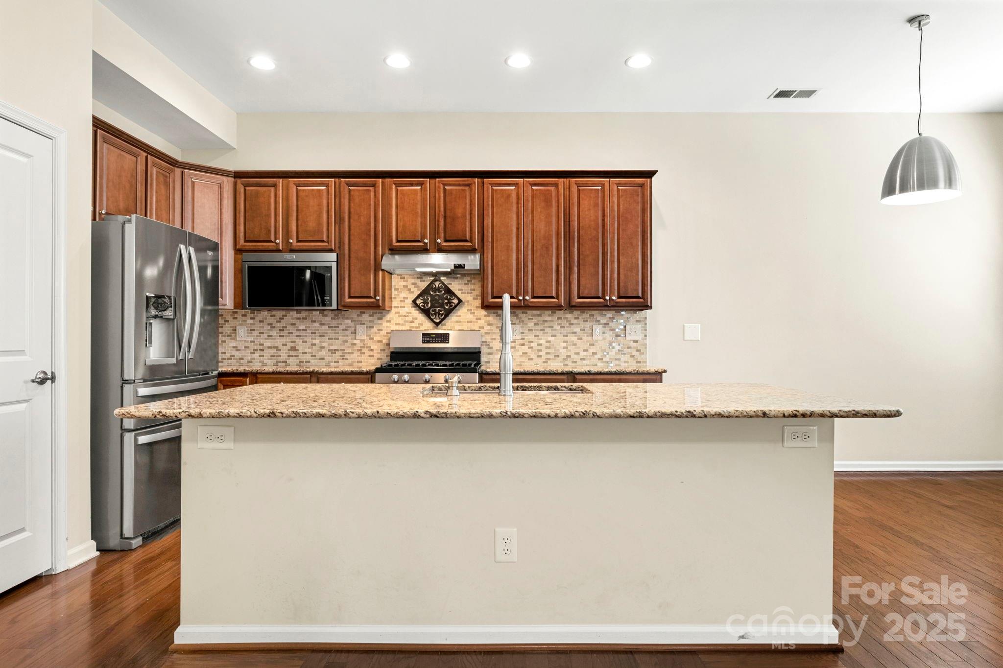 15709 Kiser Corner Lane Davidson, NC 28036 - Photo 10 of 42 a kitchen with stainless steel appliances granite countertop a refrigerator a sink a stove a microwave oven with cabinets