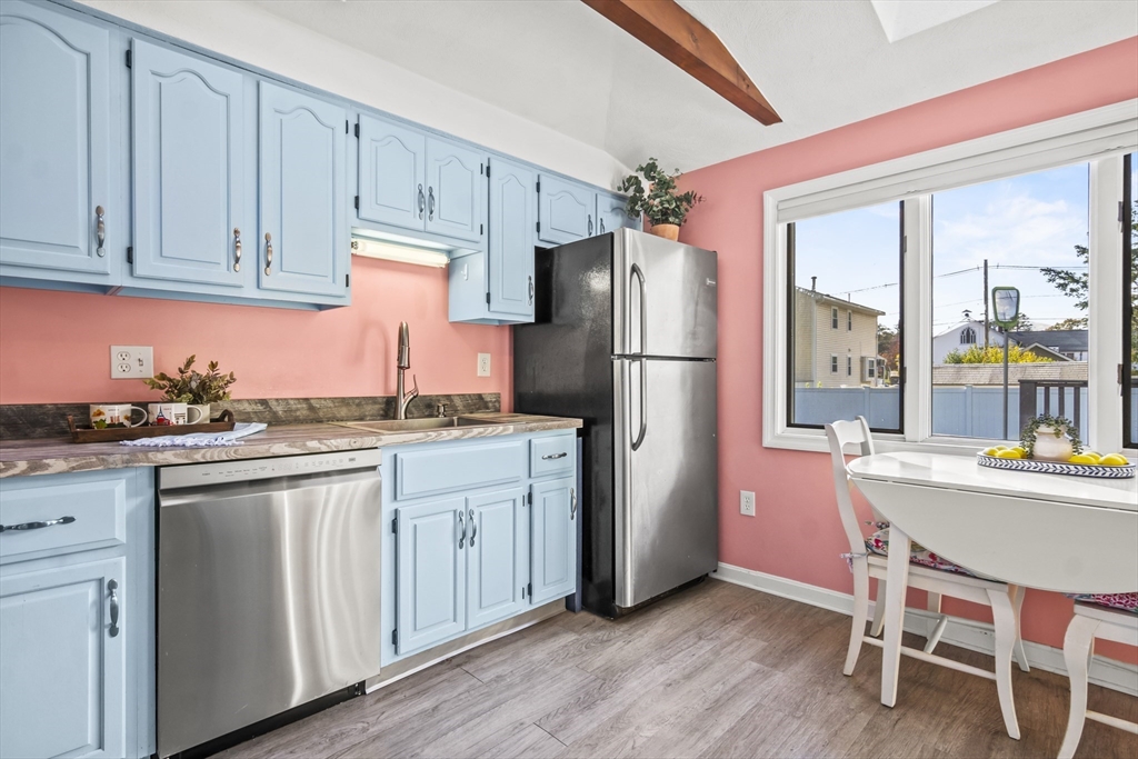 7 Allendale Avenue Billerica, MA 01821 - Photo 13 of 42 a kitchen with refrigerator cabinets dining table and chairs