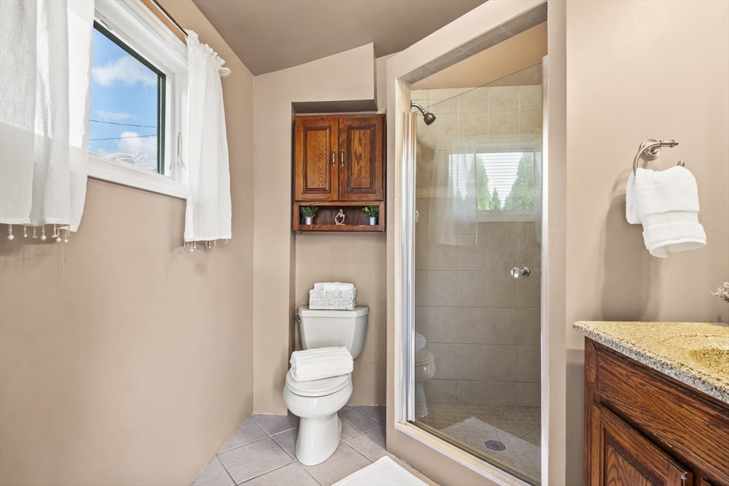 7 Allendale Avenue Billerica, MA 01821 - Photo 15 of 42 a bathroom with a granite countertop toilet a sink and shower