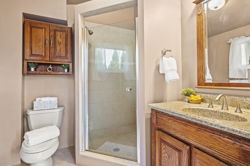 7 Allendale Avenue Billerica, MA 01821 - Photo 16 of 42 a bathroom with a granite countertop sink a toilet and a mirror
