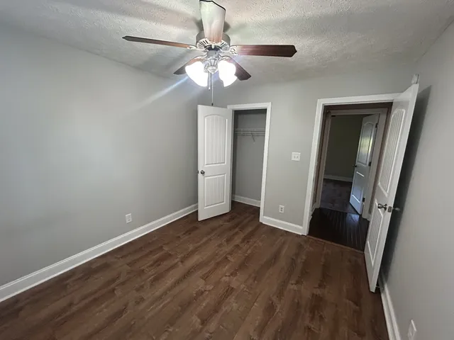 wooden floor in an empty room with a mirror