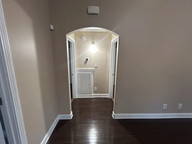 an empty room with wooden floor and door