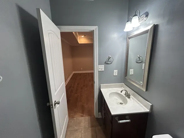 a bathroom with a sink a toilet and mirror