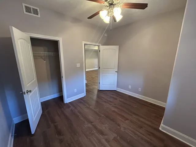 wooden floor in an empty room with a mirror