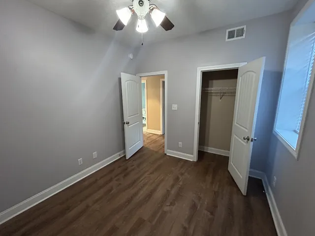 wooden floor in an empty room with a mirror