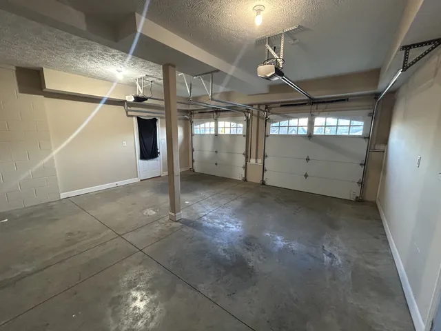 a view of a house with a backyard and wooden deck