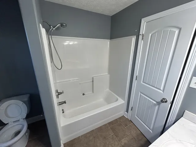 a bathroom with a tub and a shower