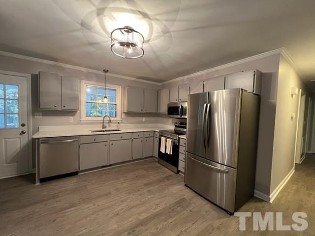 3600 Star Trek Court Raleigh, NC 27604 - Photo 15 of 25 a kitchen with granite countertop stainless steel appliances a refrigerator cabinets and wooden floor