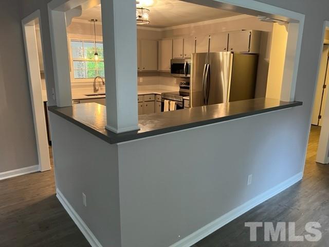 3600 Star Trek Court Raleigh, NC 27604 - Photo 16 of 25 a view of a kitchen with stainless steel appliances wooden floor and a window