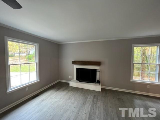 3600 Star Trek Court Raleigh, NC 27604 - Photo 18 of 25 an empty room with wooden floor fireplace and windows