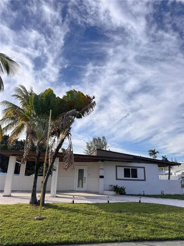 a front view of house with yard and entertaining space