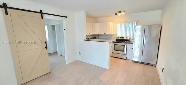 a kitchen with stainless steel appliances a refrigerator and a stove