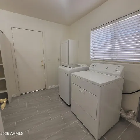 a view of a room with shelf on the wall