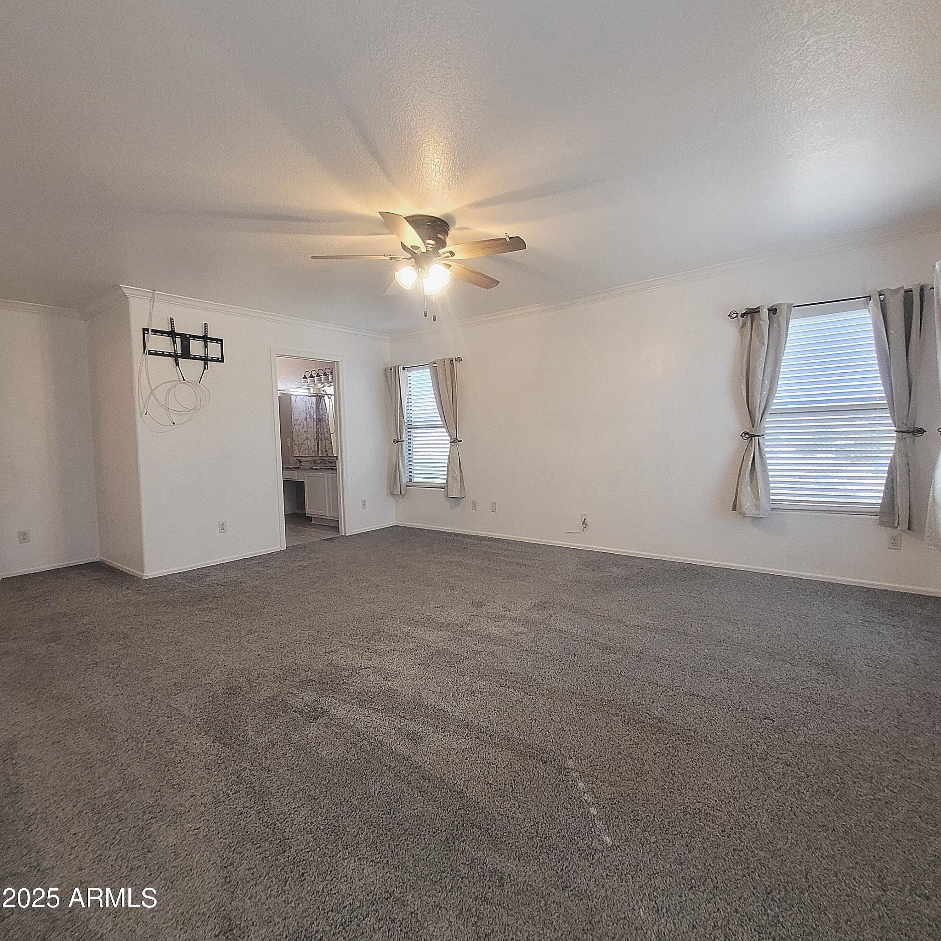 2210 East Paraiso Drive Phoenix, AZ 85024 - Photo 15 of 30 an empty room with windows and fan