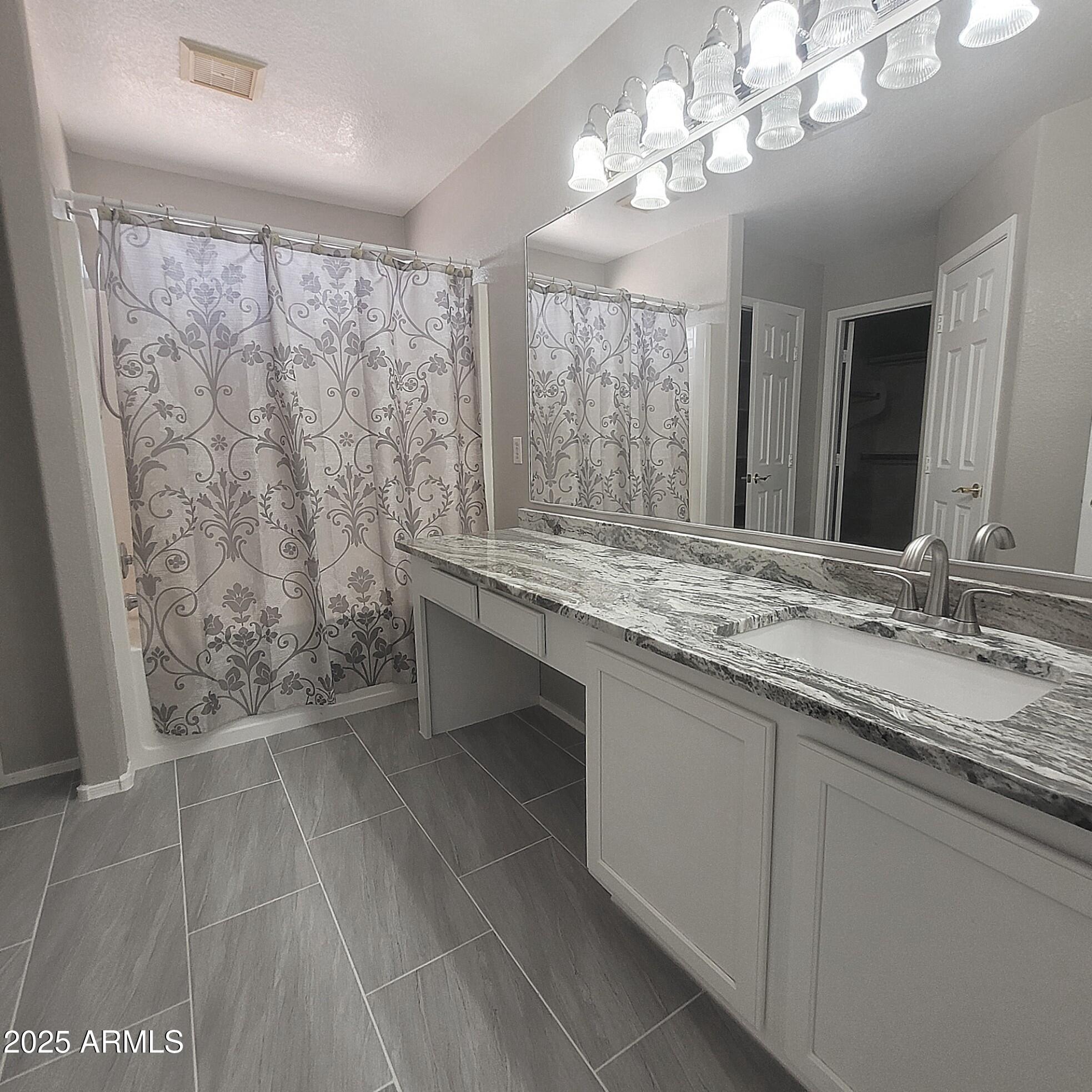 2210 East Paraiso Drive Phoenix, AZ 85024 - Photo 16 of 30 a bathroom with a granite countertop sink a toilet and a mirror