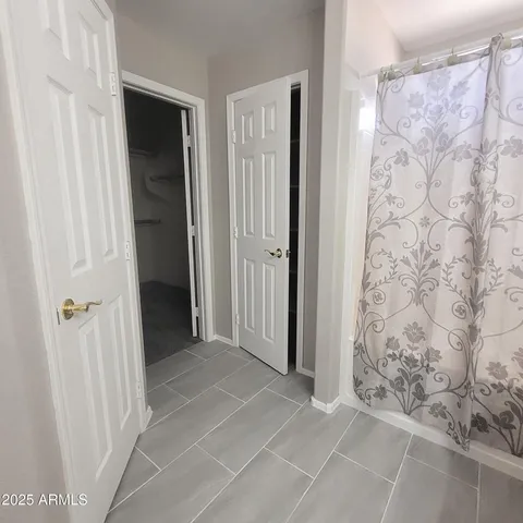 a bathroom with a granite countertop sink a toilet and a mirror